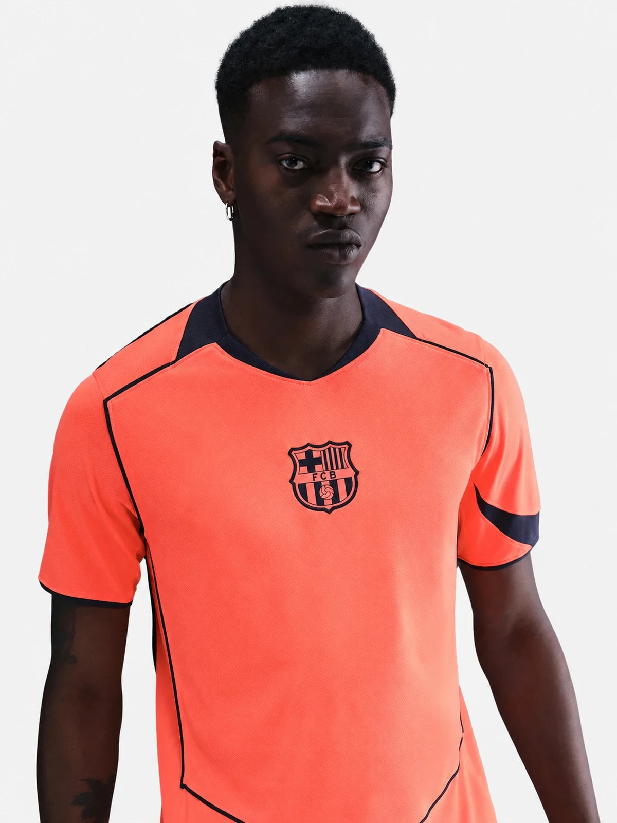 FC Barcelona 25/26 third jersey in bright orange with navy accents